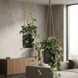 Black hanging Charlie planter by Pottery Pots, featuring a modern design with a smooth finish and sturdy hanging cord. || Abgebildete Größen: XS & S