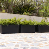 Black Fiberstone Jort planter by Pottery Pots showcasing a modern design and textured finish.